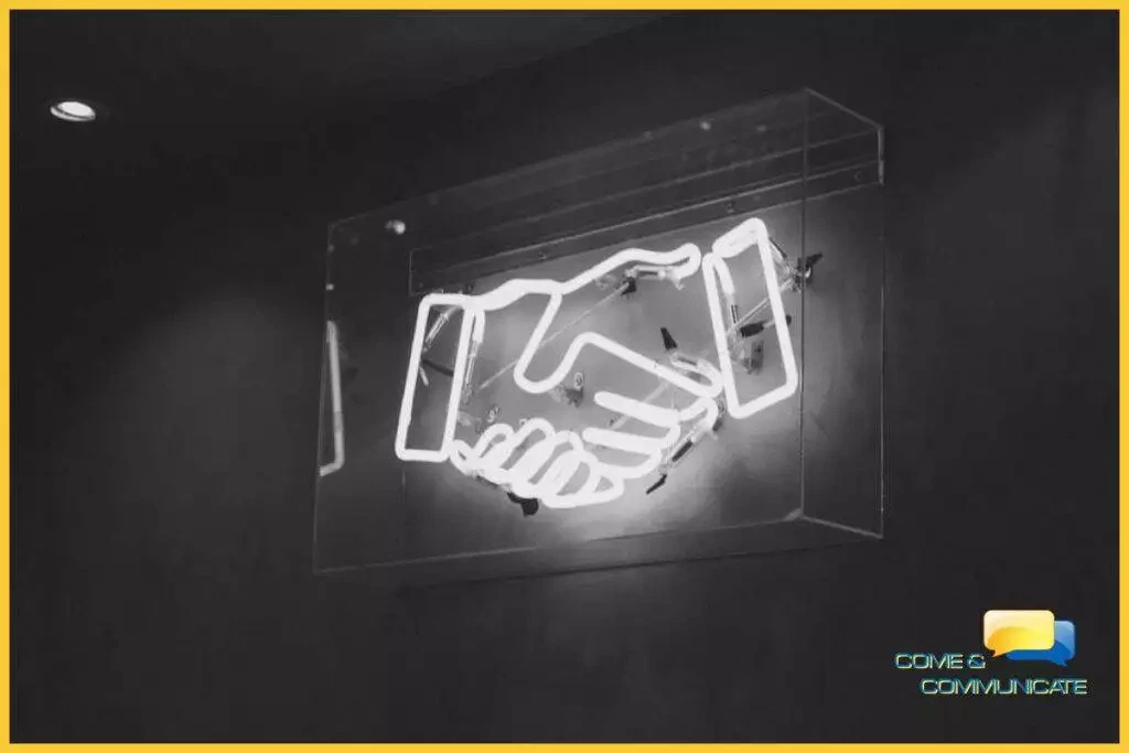 Letrero de neón de un apretón de manos